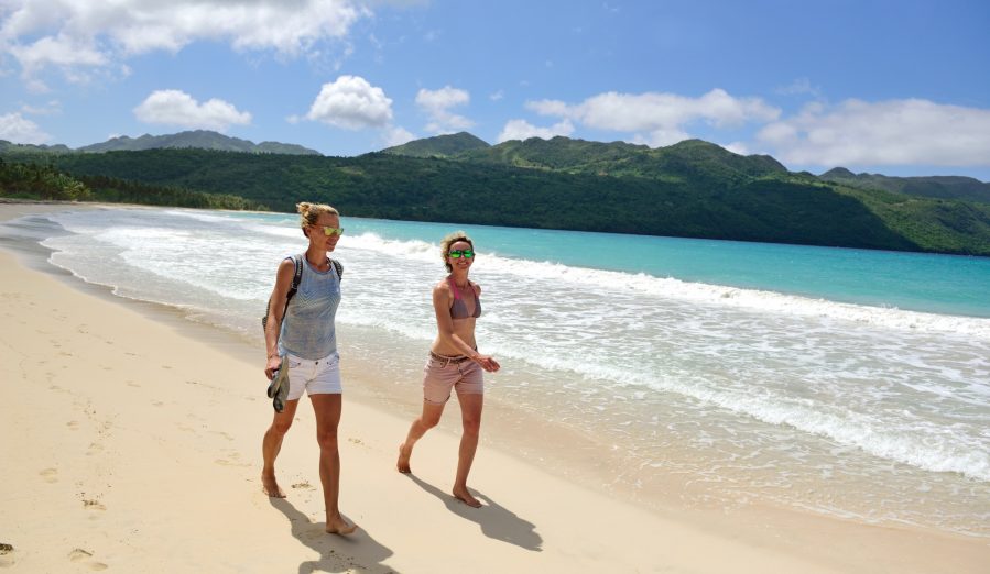 Dominican Republic, Samana, two women walking on the beach